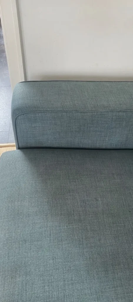Green-gray chaise after stain removal